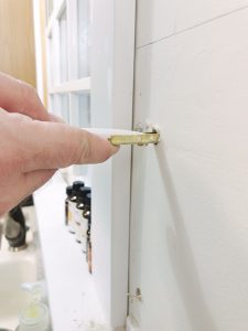 inserting toggle bolt into the wall