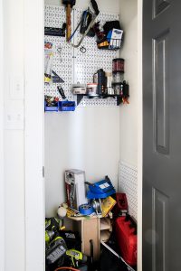 door open to show messy tool closet