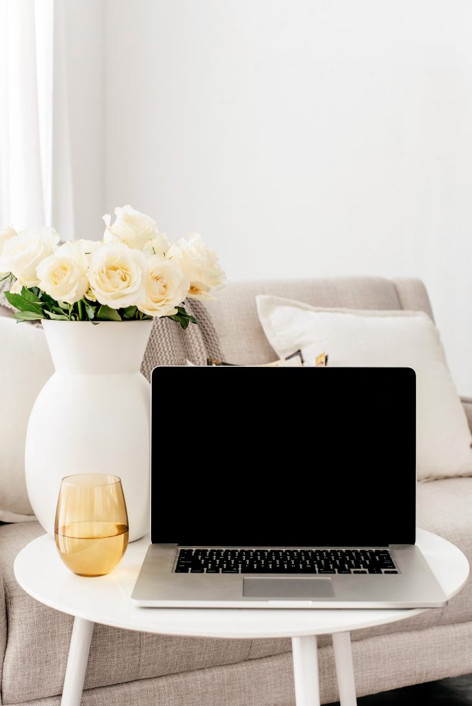 laptop and white roses