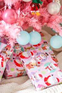 wrapped pink Christmas presents under a pink Christmas tree