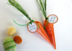 orange sugar scrub in shape of a carrot on white background