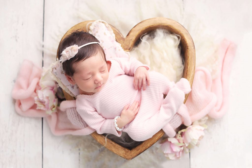 baby girl newborn photo in heart box wearing pink from Charmarie Photography newborn photos