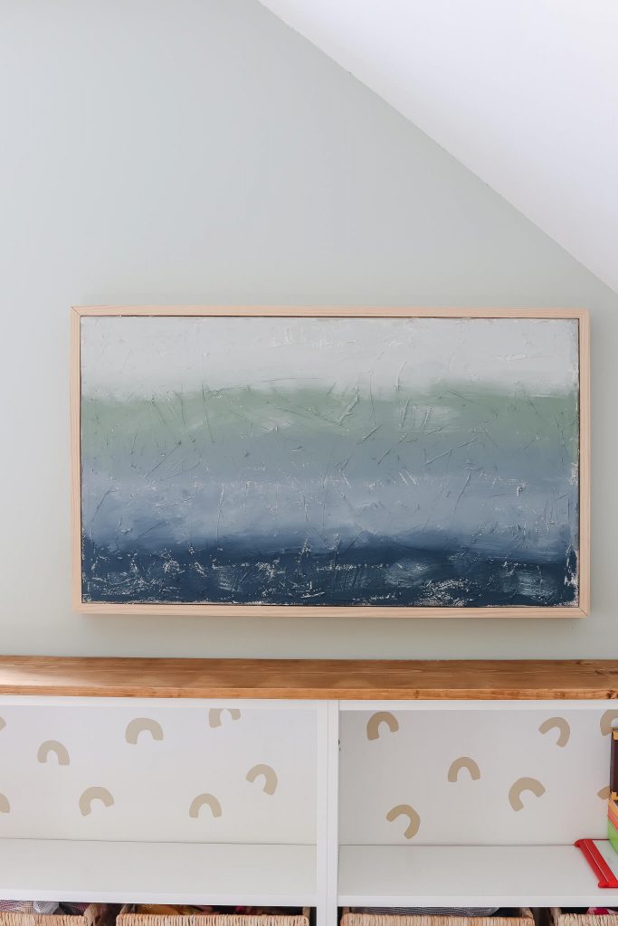 DIY canvas abstract art hanging on wall over IKEA Billy bookcases
