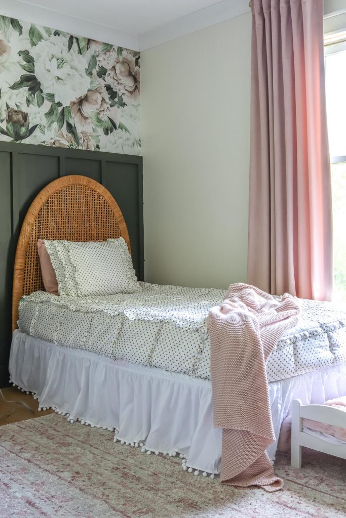 gold dot bedding with white crib sheet and vintage headboard against green nursery accent wall