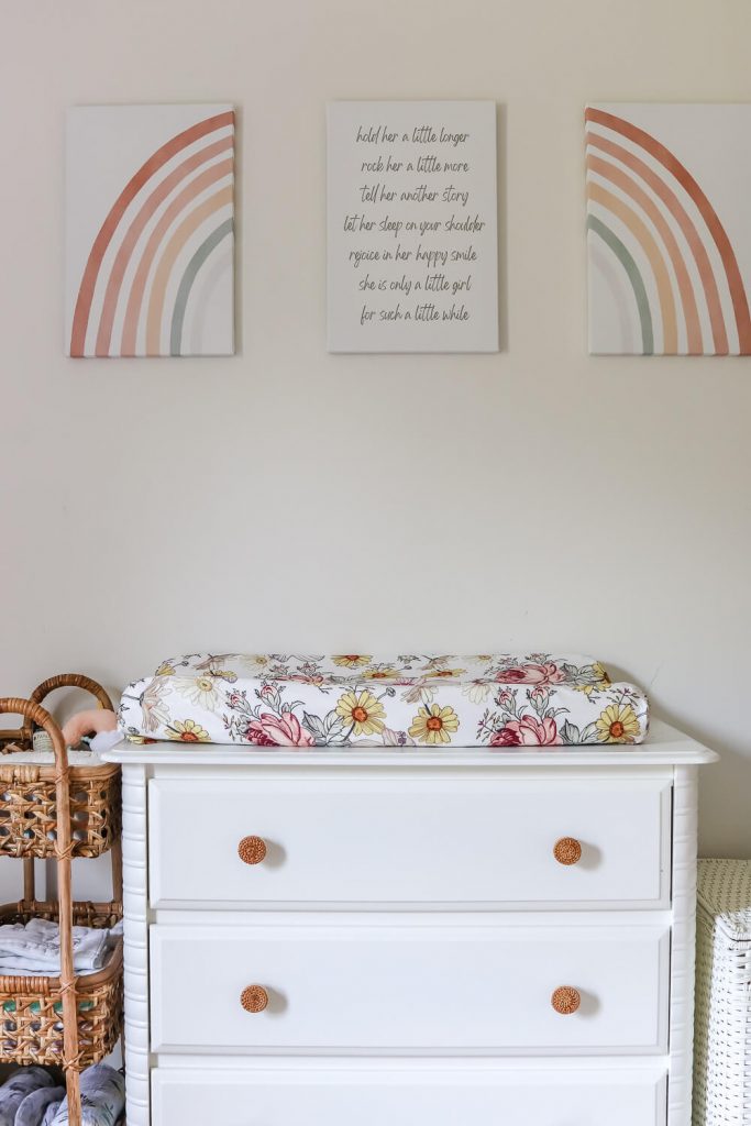 white nursery dresser with rainbow art above