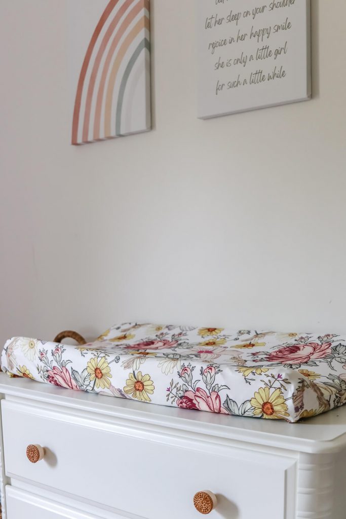 closeup of changing table with floral changing pad