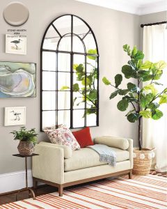 large arch mirror on the wall painted Benjamin Moore Stone Hearth