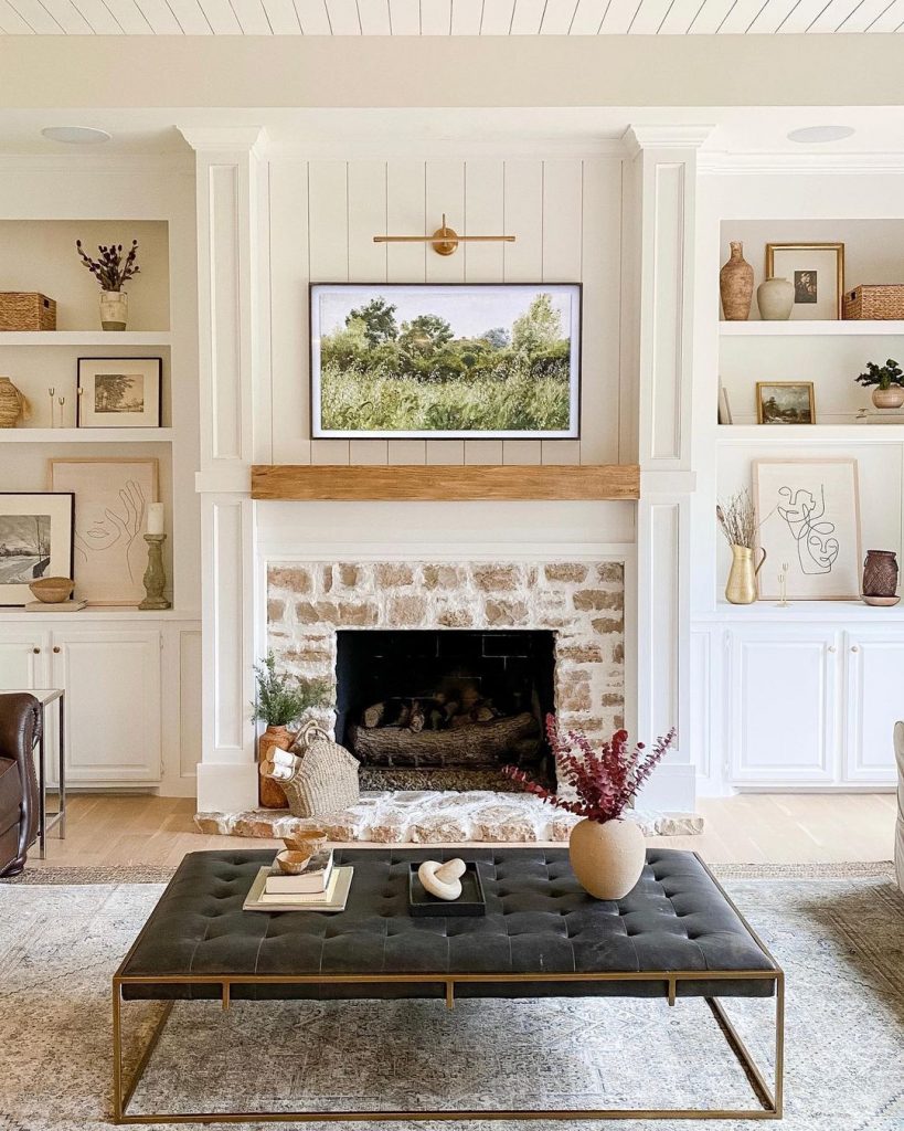 brick surround with white shiplap fireplace and Samsung frame TV above it