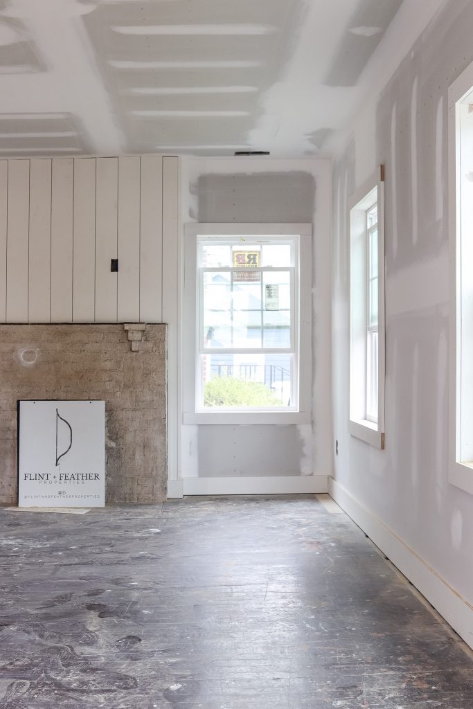 drywall in a flip house with shiplap over fireplace