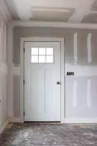 drywall in flip house investment property and white wood front door