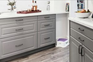 grey raised panel cabinets with white countertops