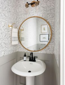 SHerwin Williams Dorian Gray board and batten in powder room with white sink and wallpaper