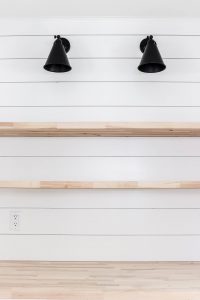 white shiplap feature wall painted Sherwin Williams Pure White with wood shelves and butcher block countertops