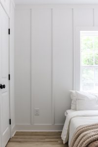 board and batten feature wall in primary bedroom painted Sherwin Williams Pure White
