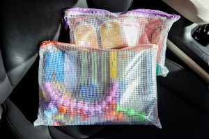 zipper bags laying on black leather seats