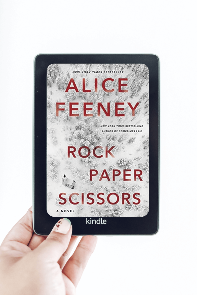 woman's hand holding kindle with rock paper scissors cover