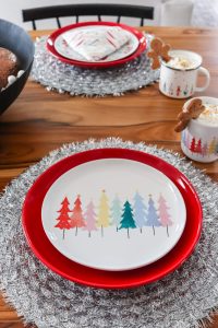 Christmas table decor from World Market with colorful Christmas tree plate and red larger plate