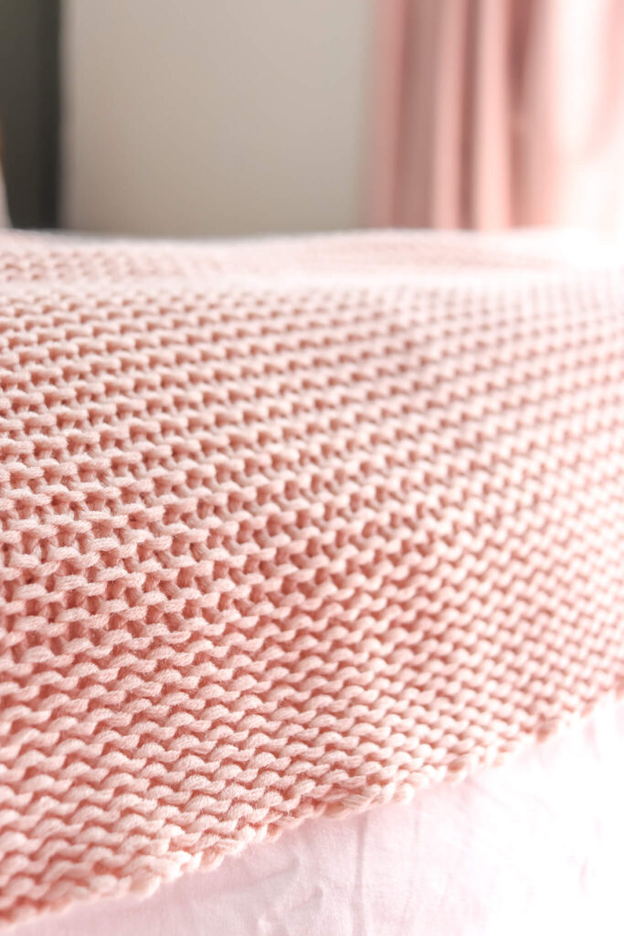 closeup of pink knit blanket on bed from Ikea