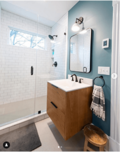 bathroom with small wood vanity and walls painted benjamin moore aegean teal
