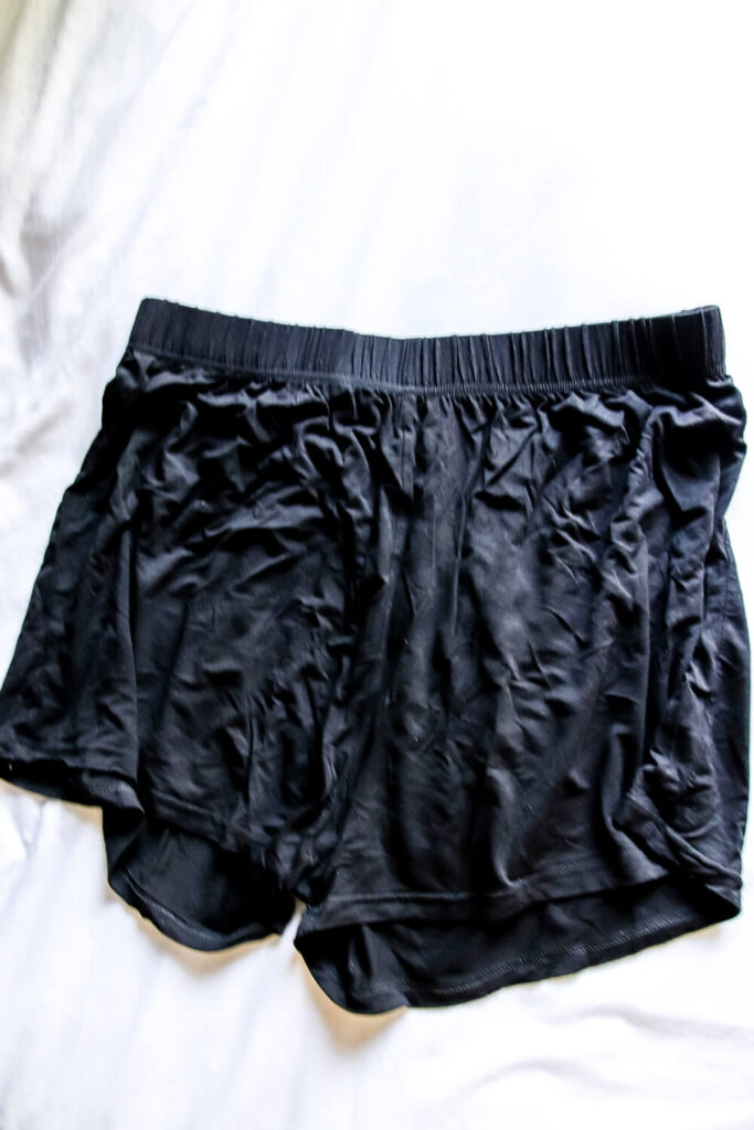 bamboo pajama shorts laying on bed with white comforter