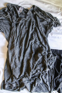 gray bamboo pajama set for women laying on white comforter