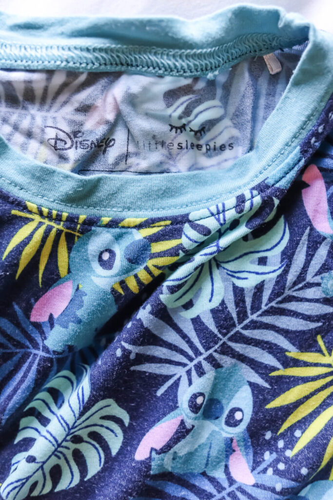 little sleepies bamboo lilo and stitch pajamas for kids laying on bed