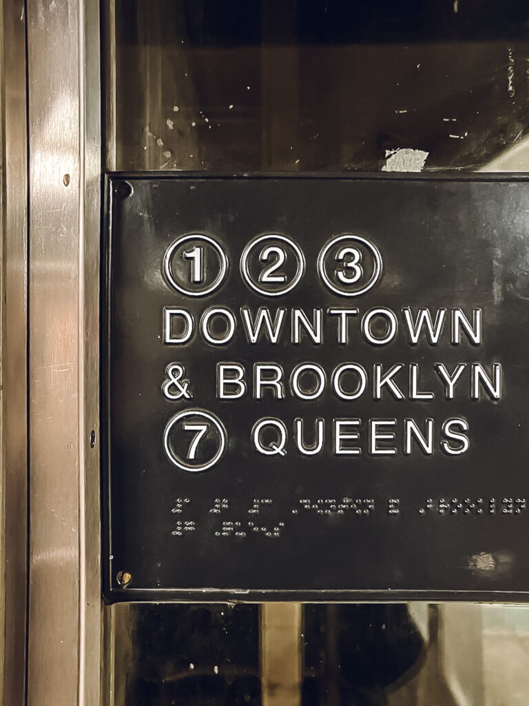 subway sign to Downtown and Brooklyn Queens New York