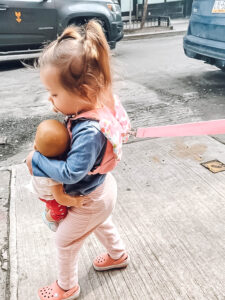 little toddler girl on pink leash