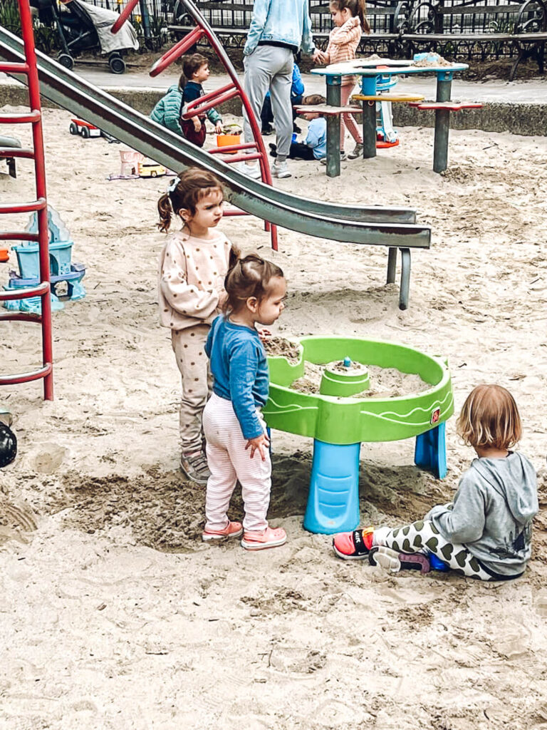 little kids playing in sand at park in New York City