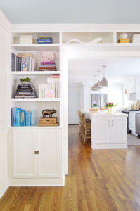 white built in bookshelves around a door casing