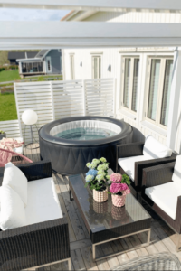 inflatable hot tub on a back deck with white privacy fence