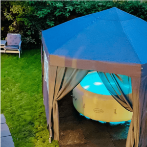 inflatable hot tub in the yard under a canopy
