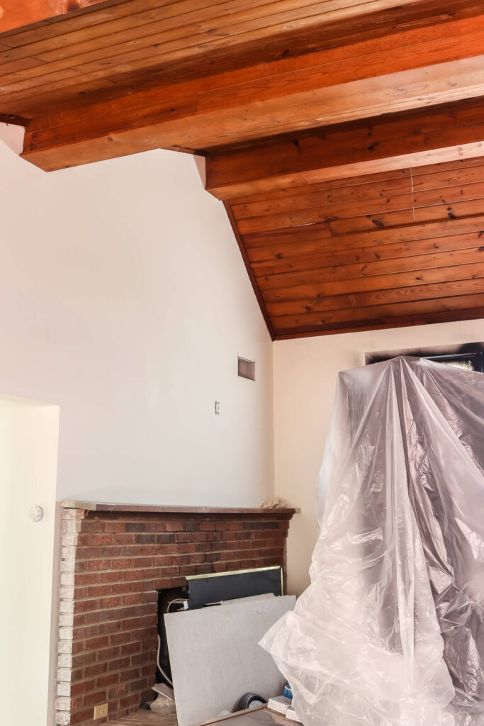large brick fireplace and wood slat ceiling