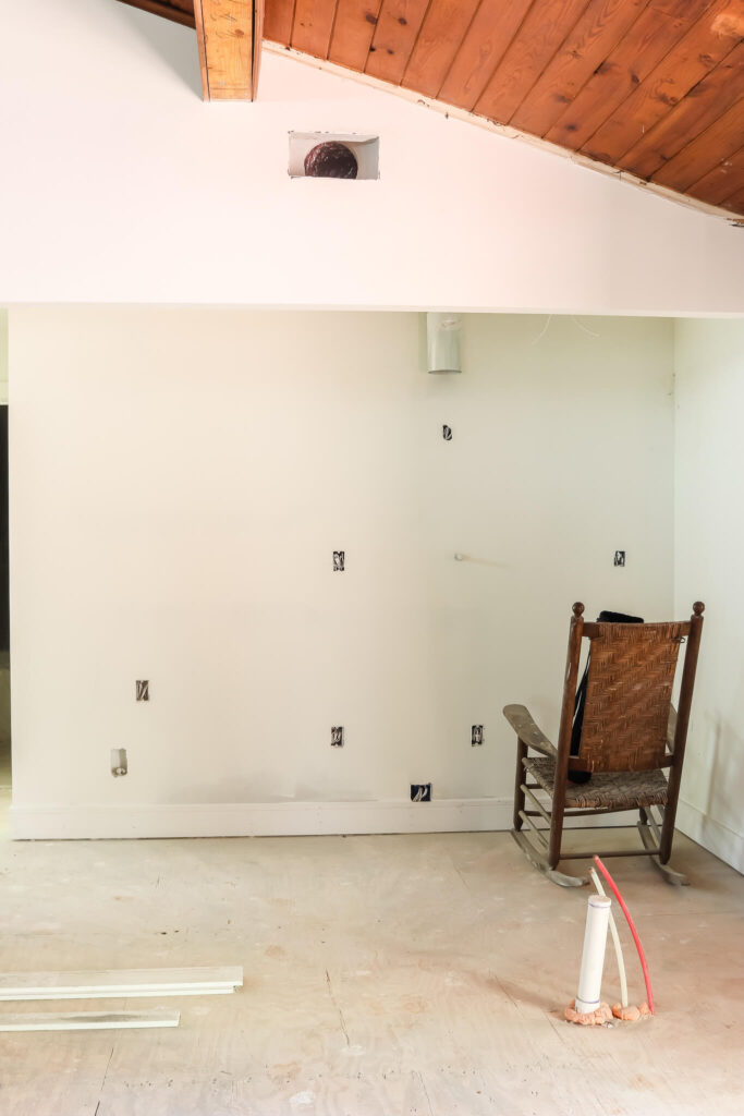 rocking chair against white drywall walls