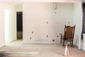 rocking chair against white drywall walls