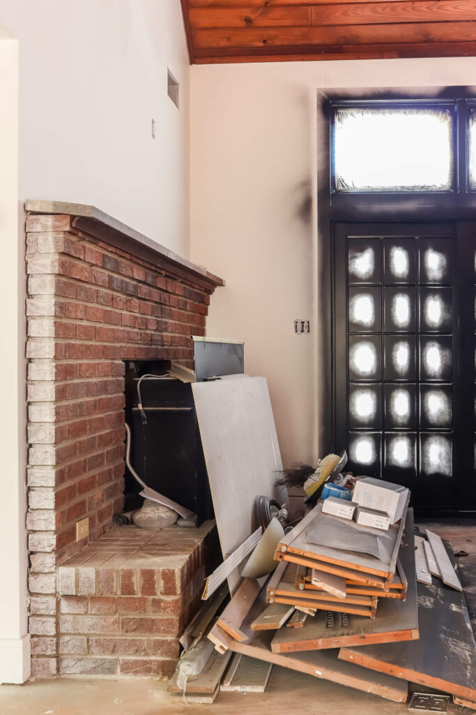black painted french doors and brick fireplace