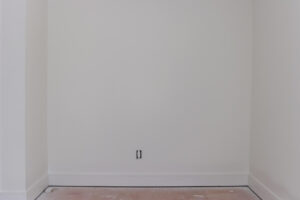 unfinished room with white walls and trim