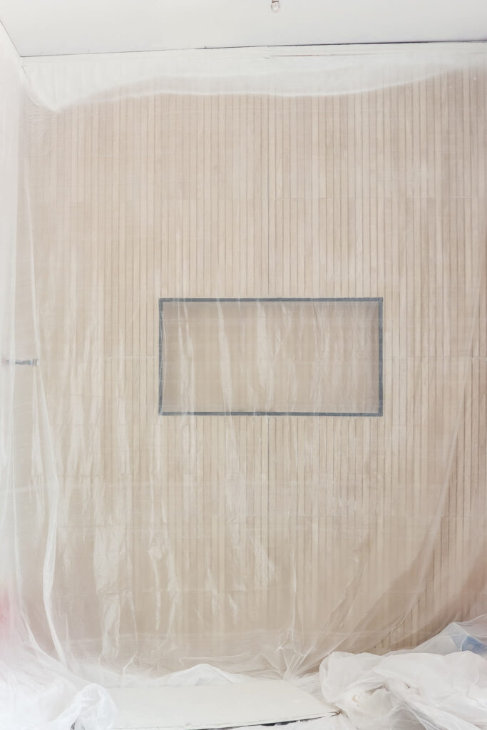 wood look tile in bathroom covered in painters plastic