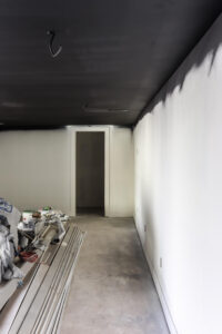 black painted ceiling in basement with white walls