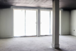 large open french doors with white column in basement