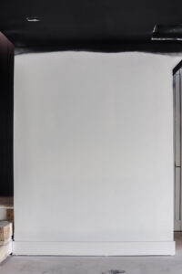 white wall with black feature wall next to stairs