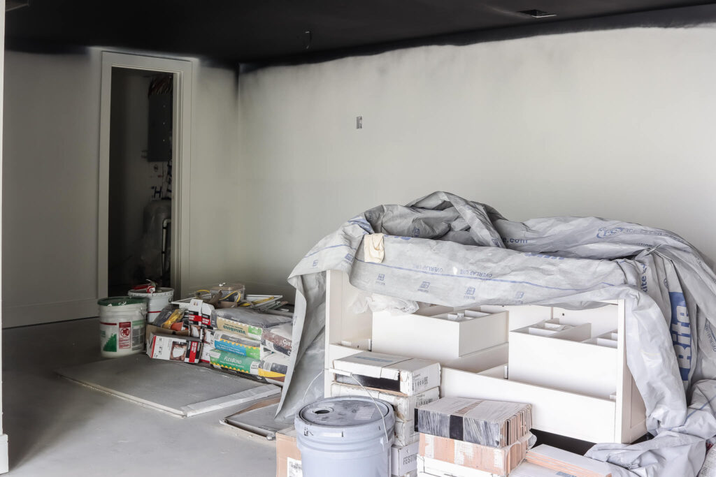 pile of construction material in basement with black ceiling