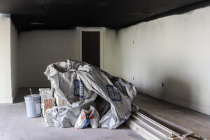 pile of construction material in basement with black ceiling