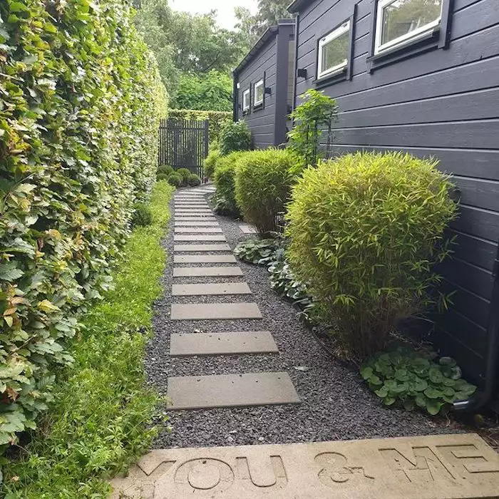 you and me inscribed in concrete walkway in exterior landscaping