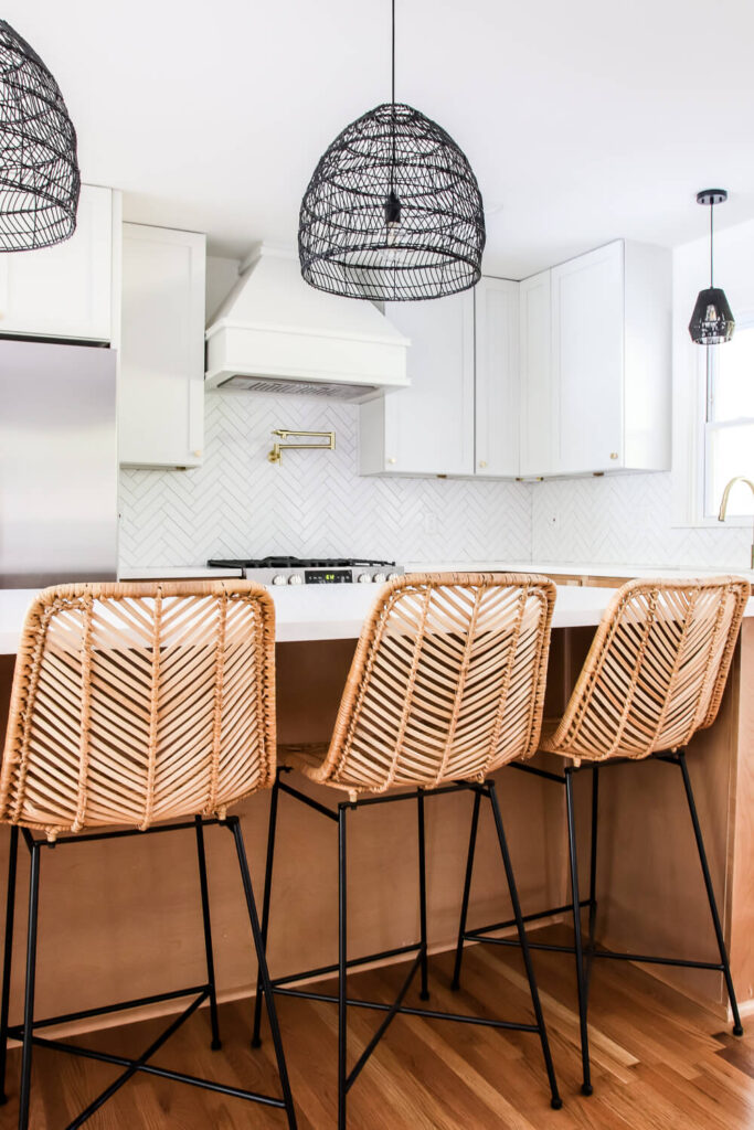 rattan bar stools and white upper kitchen cabinets with wood lower cabinets