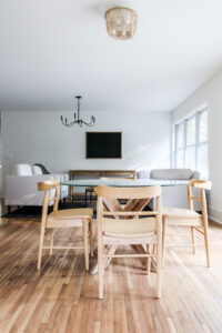 glass round table with 4 wood chairs surrounding it