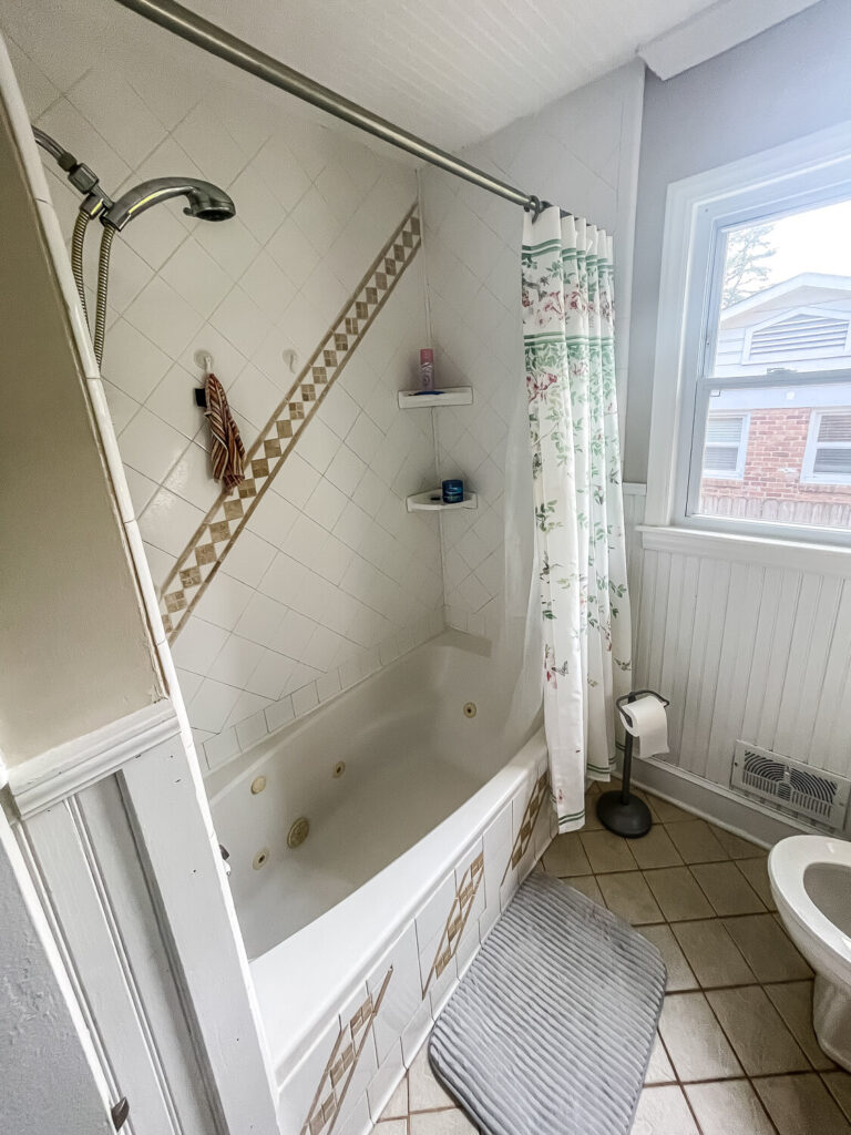 Bathroom with tub surround and shower curtain