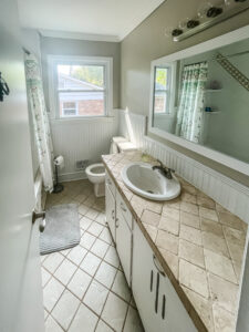 old vanity with single sink and tile top