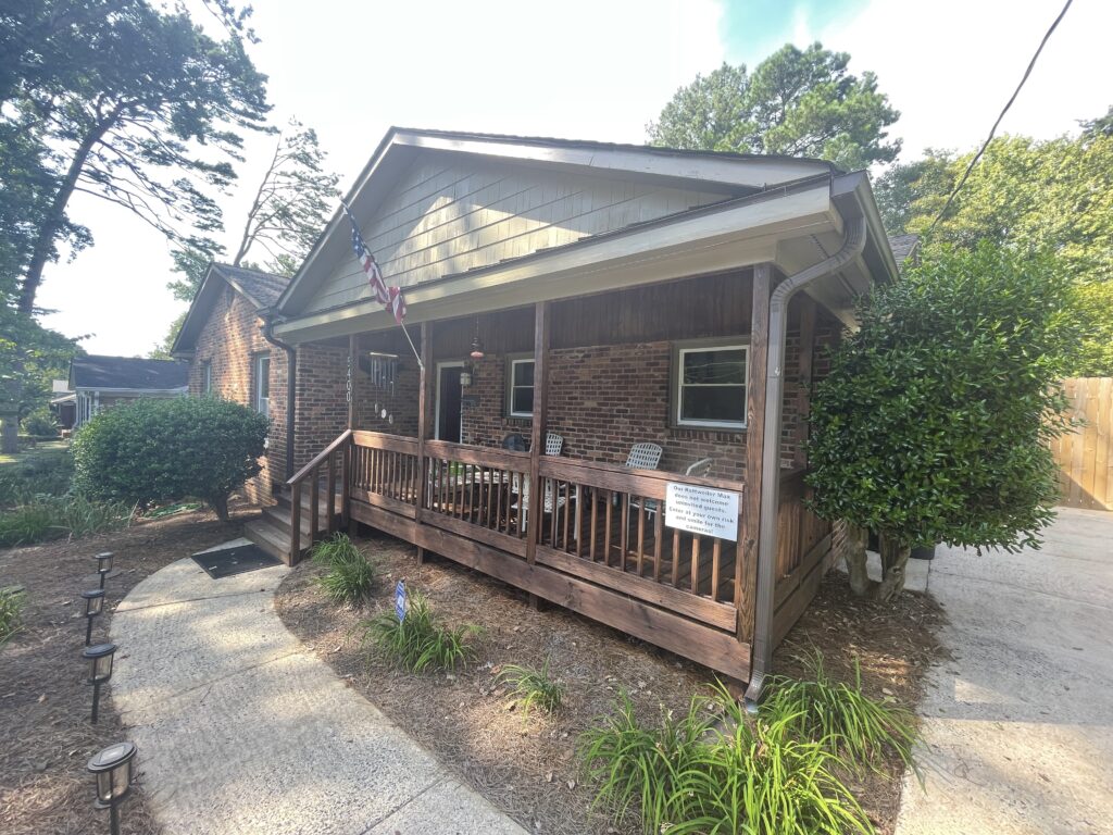 small brick ranch exterior with brown porch