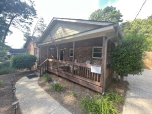 small brick ranch exterior with brown porch